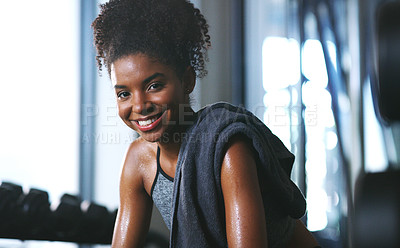 Buy stock photo Portrait of a sporty young woman taking a break while exercising at the gym