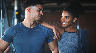 Buy stock photo Shot of two sporty young people at the gym