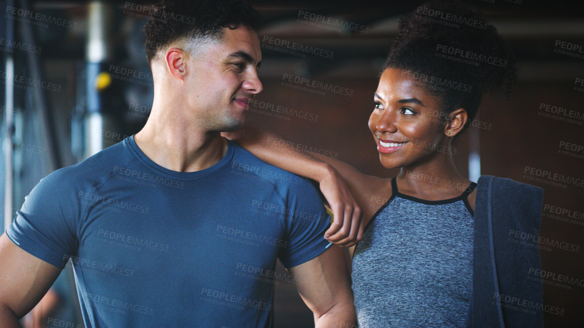 Buy stock photo Shot of two sporty young people at the gym