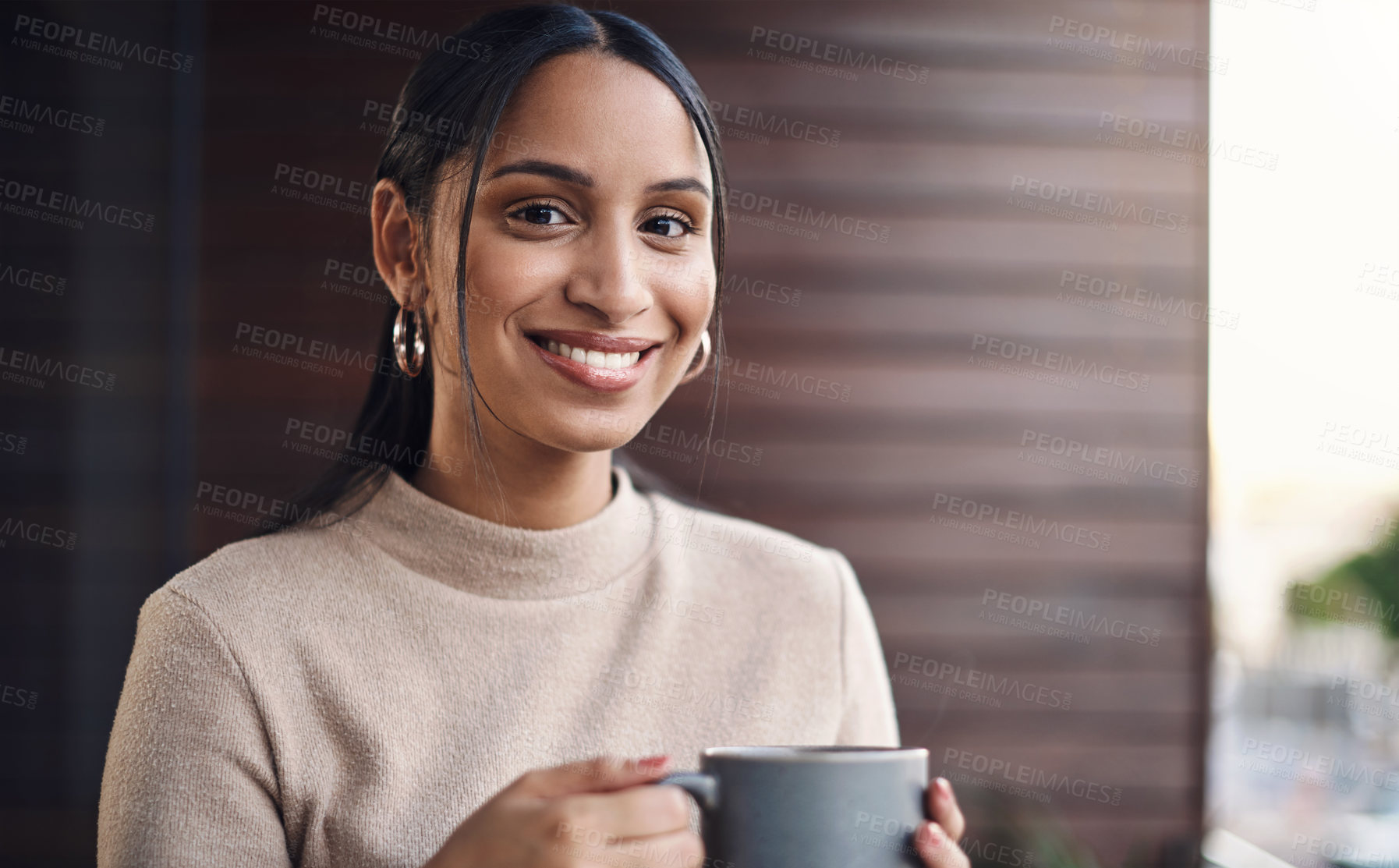 Buy stock photo Cropped portrait of an attractive young businesswoman drinking her coffee while working in the office