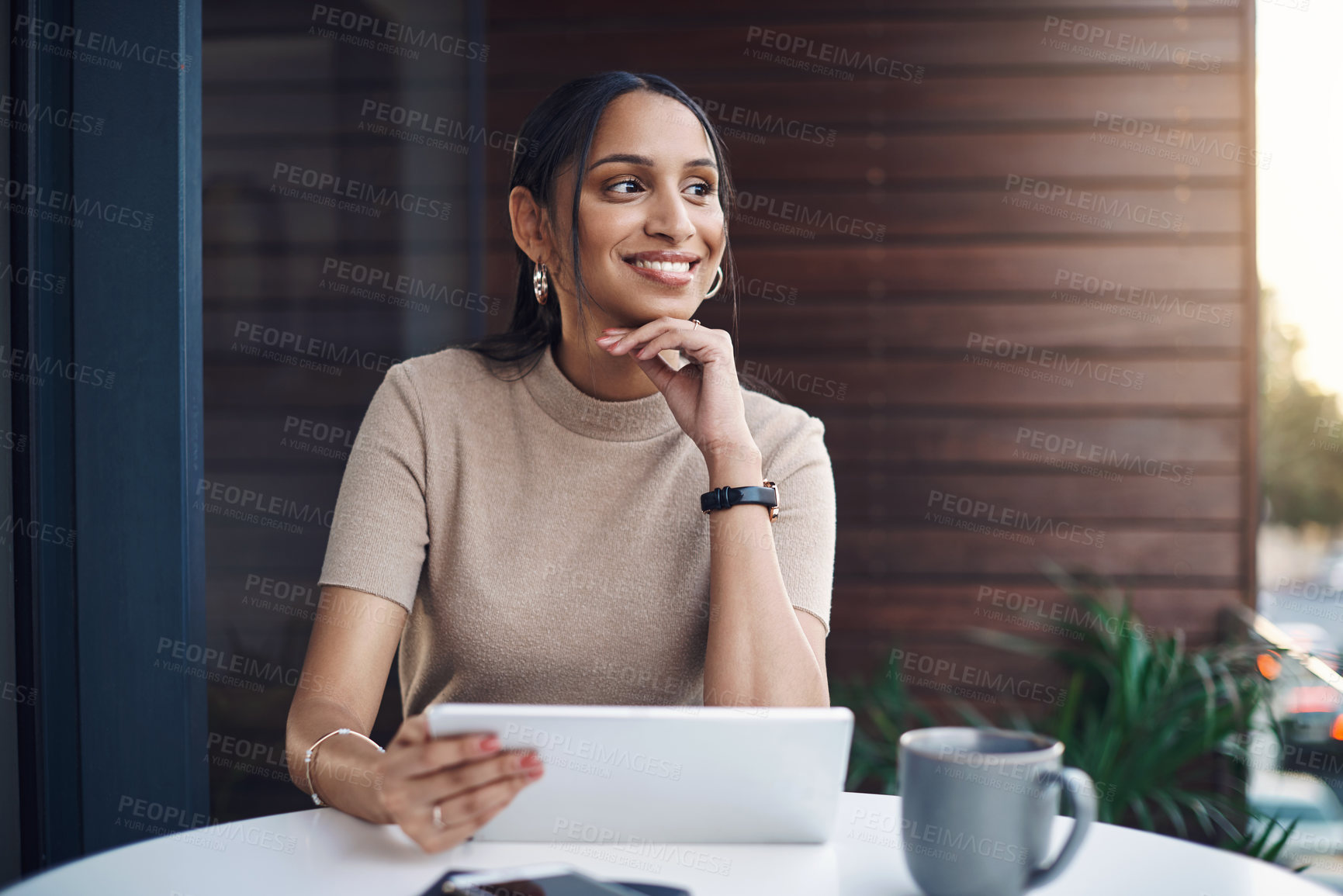 Buy stock photo Cropped shot of an attractive young businesswoman using her tablet while working in the office