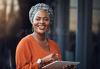 Buy stock photo Cropped shot of an attractive businesswoman using her tablet while standing in the office