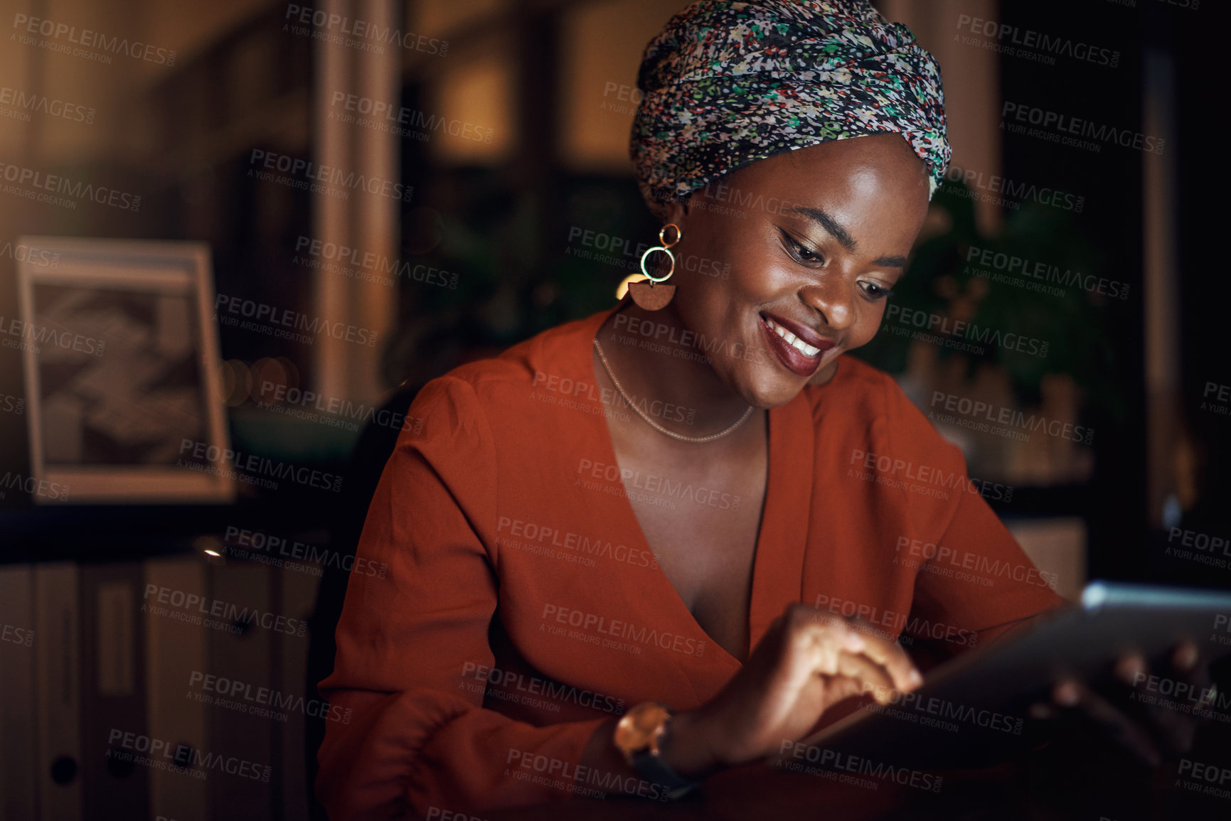 Buy stock photo Black, business woman and working late as entrepreneur with tablet, happy and confident in office. Female person, technology and overtime for deadline, project or editing, as online content creator