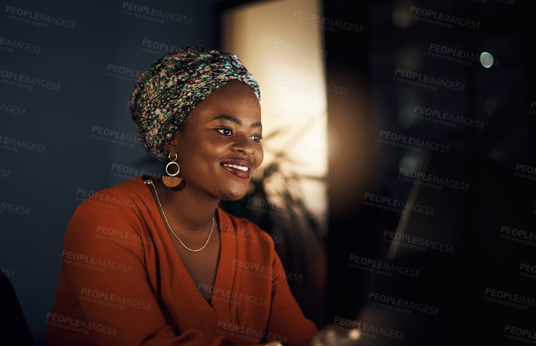 Buy stock photo Shot of a young businesswoman working in an office at night