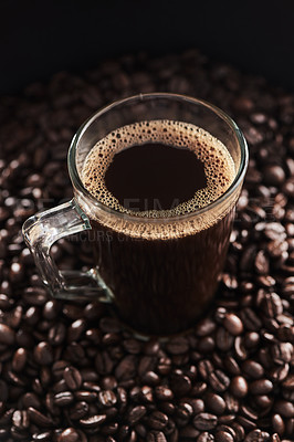 Buy stock photo Closeup shot of a cup of black coffee surrounded by coffee beans