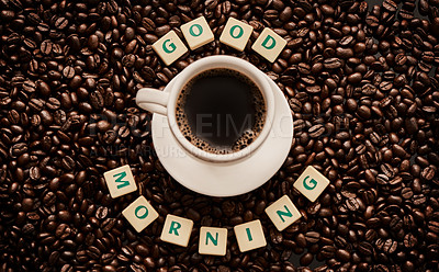 Buy stock photo Closeup shot of a cup of coffee surrounded by block letters forming the words 
