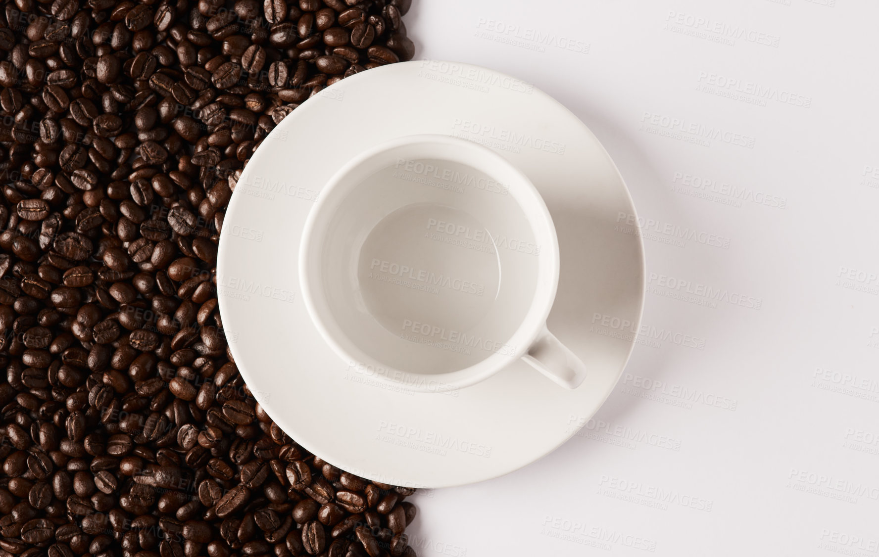 Buy stock photo Closeup shot of an empty cup and saucer against a half-and-half background of coffee beans