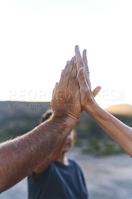 Buy stock photo Cropped shot of a family joining their hands in solidarity outdoors