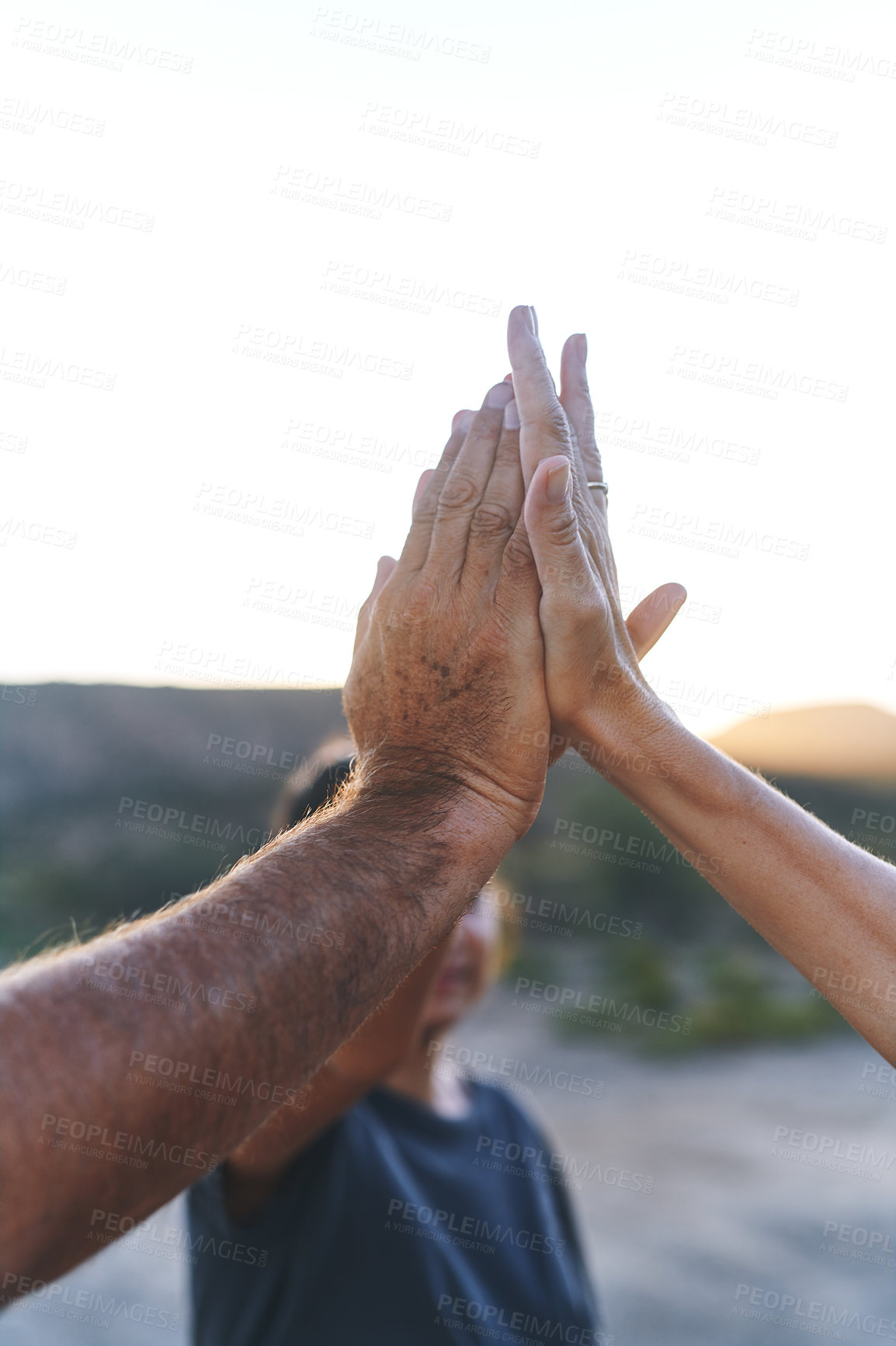 Buy stock photo Cropped shot of a family joining their hands in solidarity outdoors