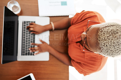 Buy stock photo High angle shot of a young businesswoman working on a laptop in an office