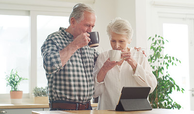 Buy stock photo Cropped shot of a senior couple looking at something on a digital tablet together