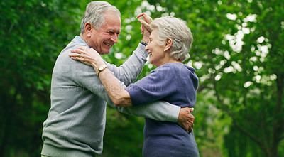 Buy stock photo Shot of a happy senior couple dancing in the park