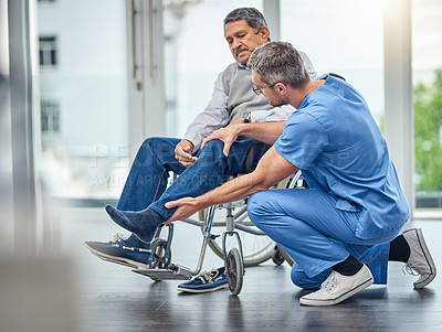 Buy stock photo Shot of a nurse helping a senior man in a wheelchair