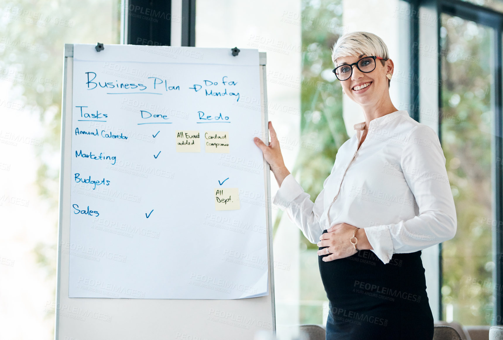 Buy stock photo Shot of a pregnant businesswoman using a whiteboard while giving a presentation in an office