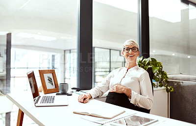 Buy stock photo Portrait of a pregnant businesswoman sitting at a desk in an office