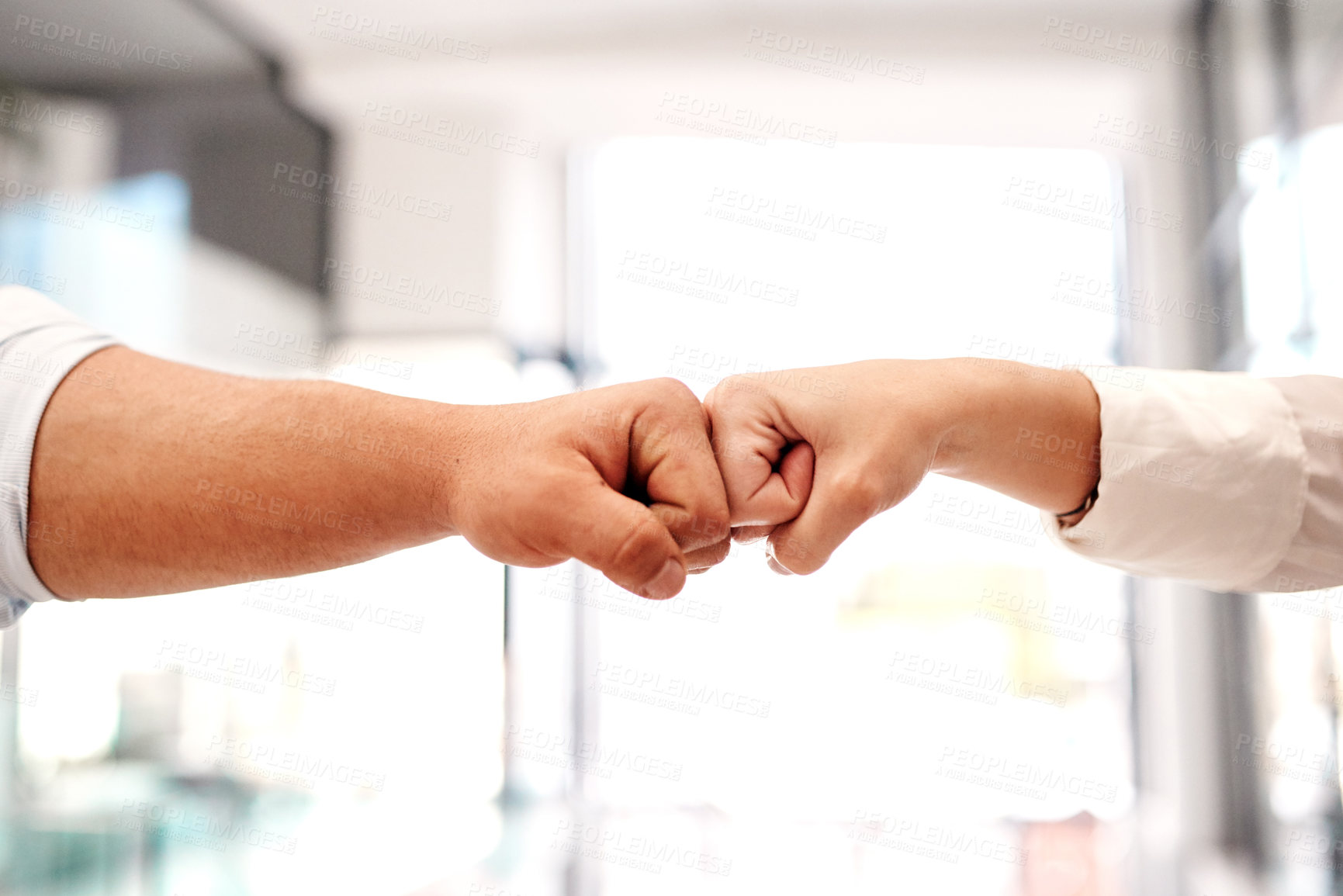 Buy stock photo Closeup shot of two unrecognisable businesspeople giving each other a fist bump