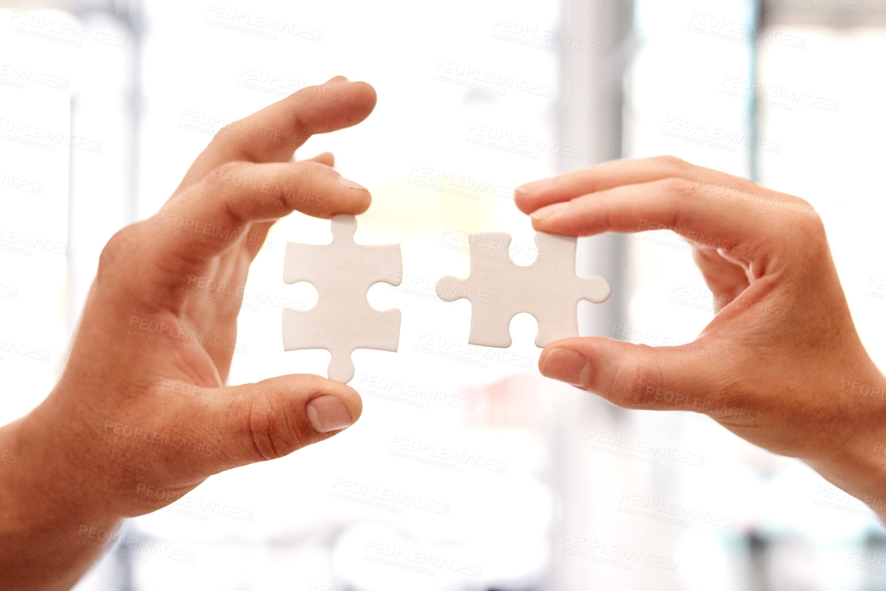 Buy stock photo Closeup shot of two unrecognisable businesspeople holding puzzle pieces together