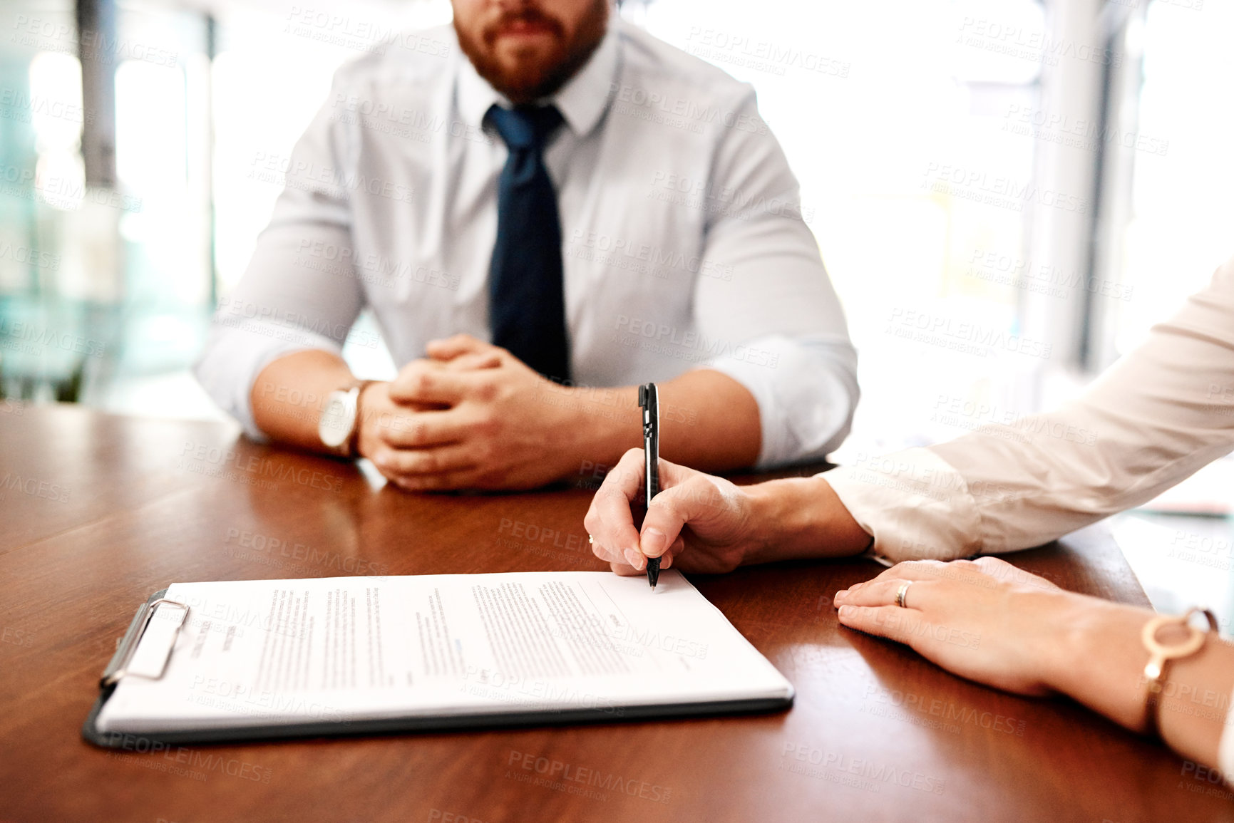 Buy stock photo Closeup shot of two businesspeople going through paperwork together in an office