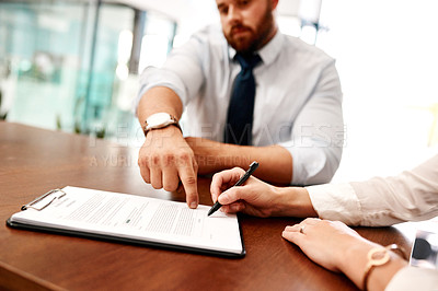 Buy stock photo Closeup shot of two businesspeople going through paperwork together in an office