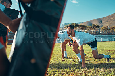 Buy stock photo Shot of rugby players training with tackle bags on the field