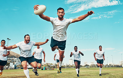 Buy stock photo Shot of a rugby player scoring a try while playing on a field