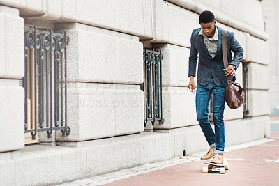 Buy stock photo Shot of a young businessman riding a skateboard through the city