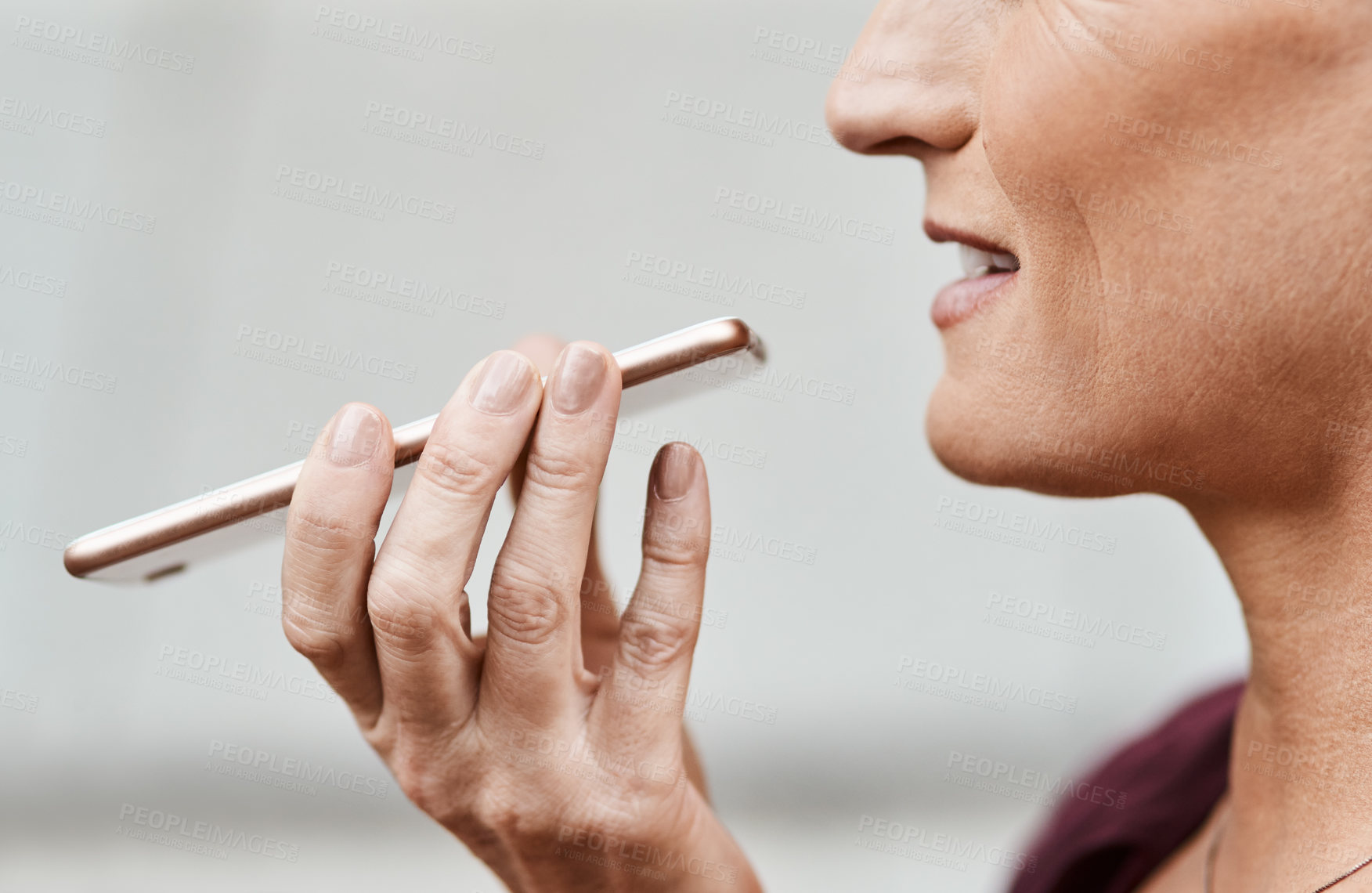Buy stock photo Cropped shot of a businesswoman using a smartphone against an urban background