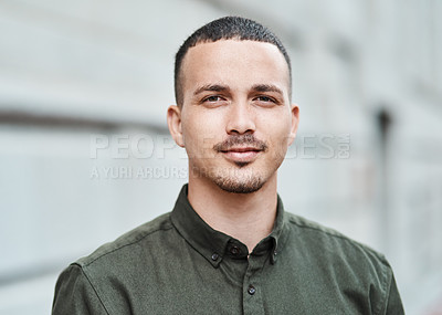 Buy stock photo Closeup face of a serious, motivated and ambitious man standing outside in a city, town or downtown alone. Portrait, headshot and face of social worker or volunteer looking forward with trust or care