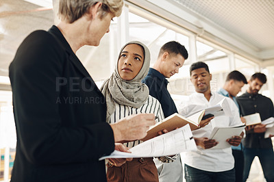 Buy stock photo Cropped shot of a group of business colleagues looking over their notes after a successful meeting in the boardroom