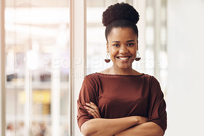 Buy stock photo Cropped portrait of an attractive young businesswoman standing with her arms crossed in the office