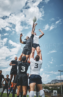 Buy stock photo Shot of two rugby teams competing over a ball during a line out of a rugby match outside on a filed