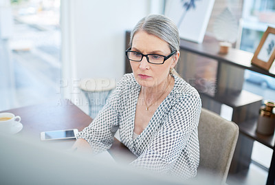 Buy stock photo Shot of a mature businesswoman working on a computer in an office