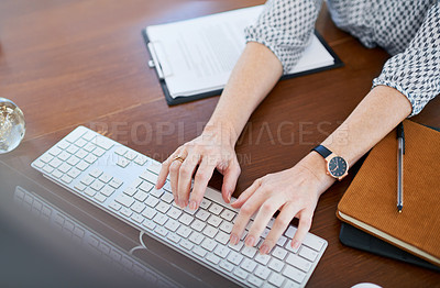 Buy stock photo High angle shot of an unrecognisable businesswoman working on a computer in an office