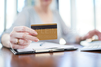 Buy stock photo Closeup shot of an unrecognisable businesswoman holding a credit card in an office