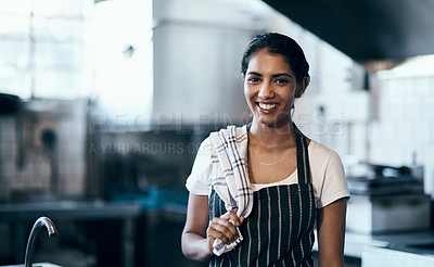 Buy stock photo Portrait of a confident young woman standing in the kitchen of her cafe