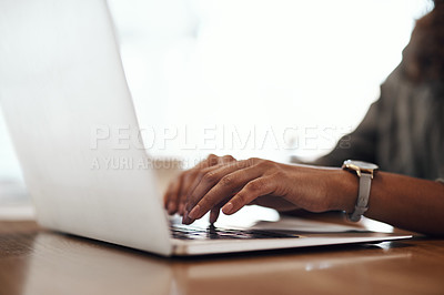 Buy stock photo Cropped shot of a woman using a laptop in a cafe
