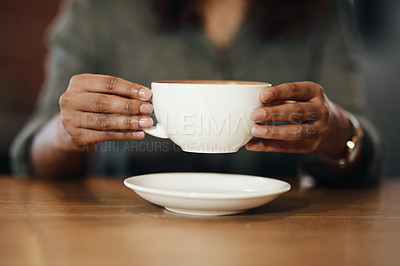 Buy stock photo Cropped shot of a woman having coffee in a cafe