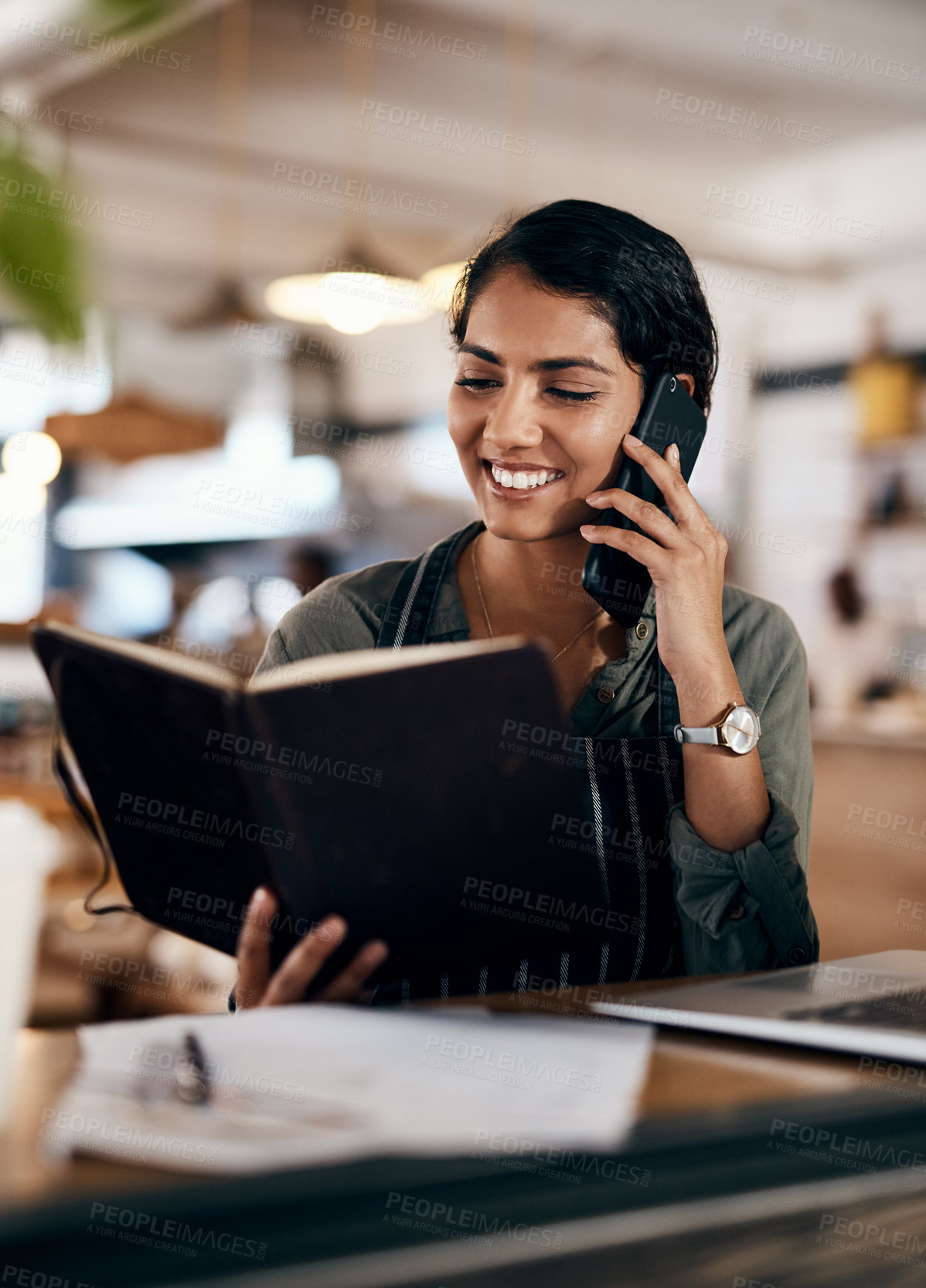 Buy stock photo Cafe woman, notebook and phone call for order details, online shopping and ecommerce information. Laptop, talking or restaurant waitress with technology for booking confirmation, reservation or sales