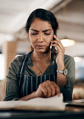 Buy stock photo Young and confused business owner on the phone making a stock order for her cafe, restaurant or coffee shop. A female employee, manager or store owner looking at a book of products or inventory.