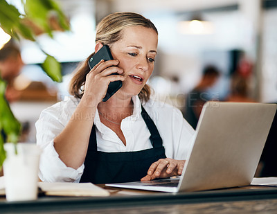 Buy stock photo Coffee shop owner on a phone call while working online on her laptop inside a local cafe store. Contact us, learn about us and talk to our baristas, managers and small startup business entrepreneurs