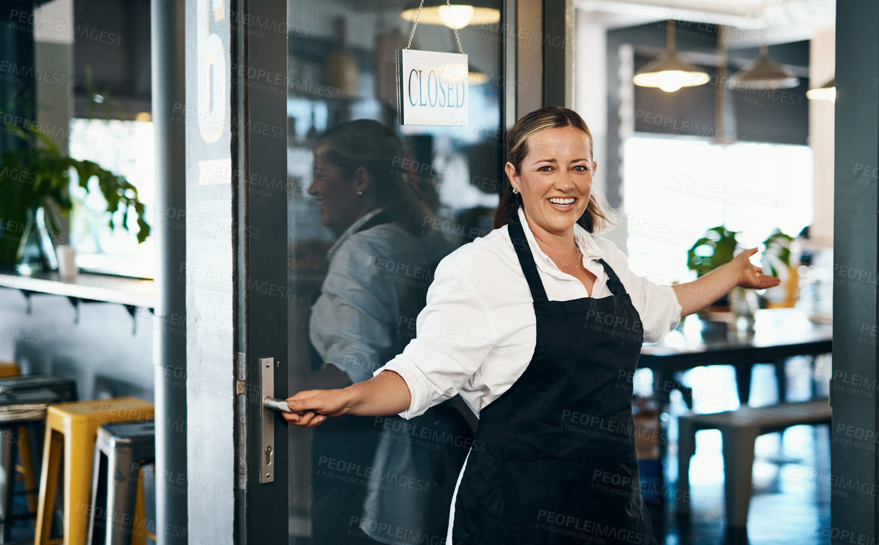 Buy stock photo Shot of a mature woman opening the door to her cafe