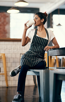 Buy stock photo Woman, waitress and drinking with coffee at cafe for break, rest or morning at indoor restaurant. Young, female person or barista enjoying beverage, latte or cappuccino by counter at retail shop