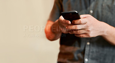 Buy stock photo Closeup shot of an unrecognisable man using a cellphone