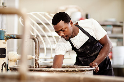 Buy stock photo Cropped shot of a young man working in a bakery