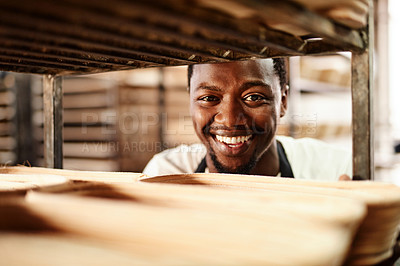 Buy stock photo Cropped shot of a male baker pushing a baking trolley