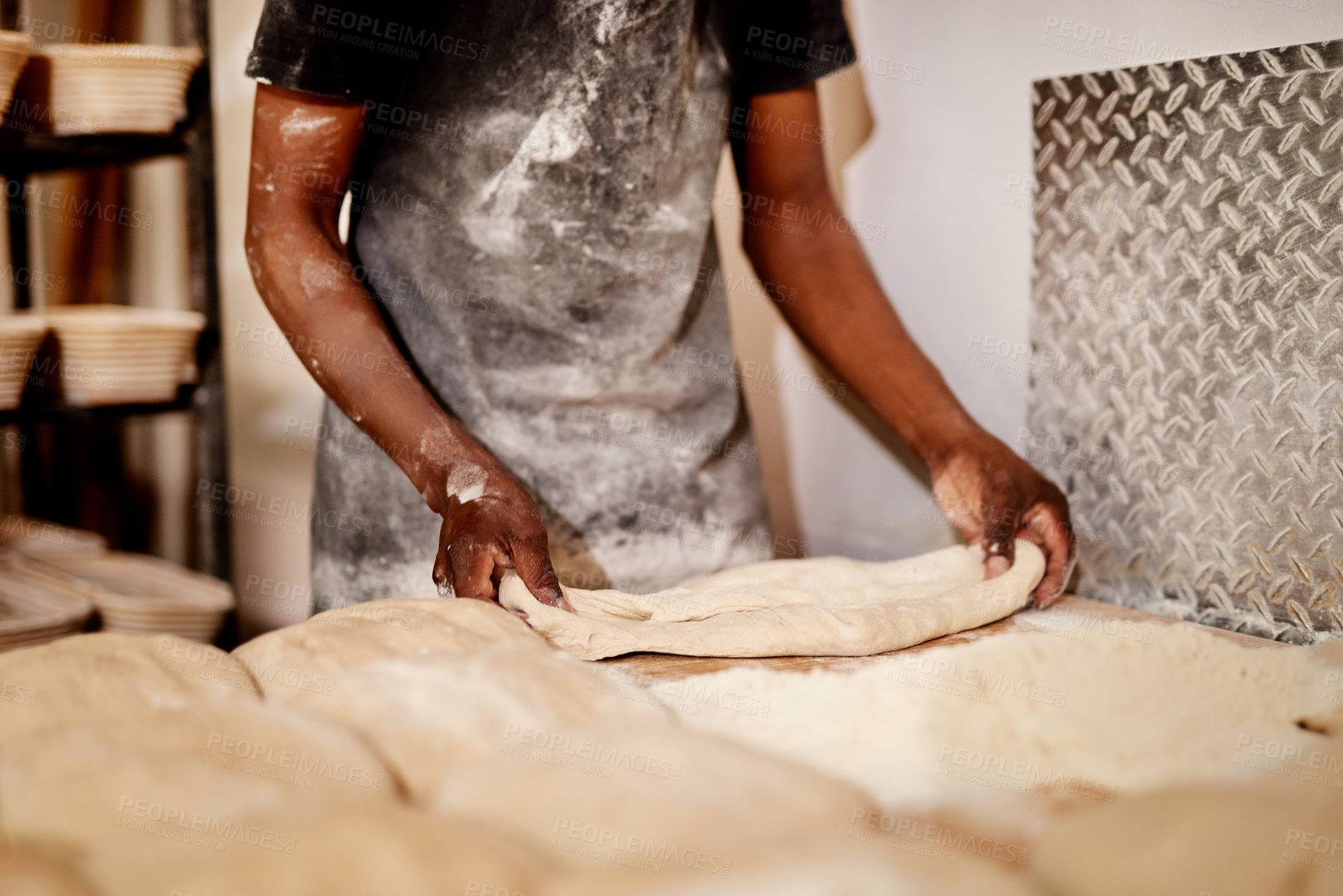 Buy stock photo Man, bakery and kneading with dough for bread, rolls or pastry production on wooden table. Closeup, hands or baker with flour, ingredients or rolling wheat for handmade food or heast at factory