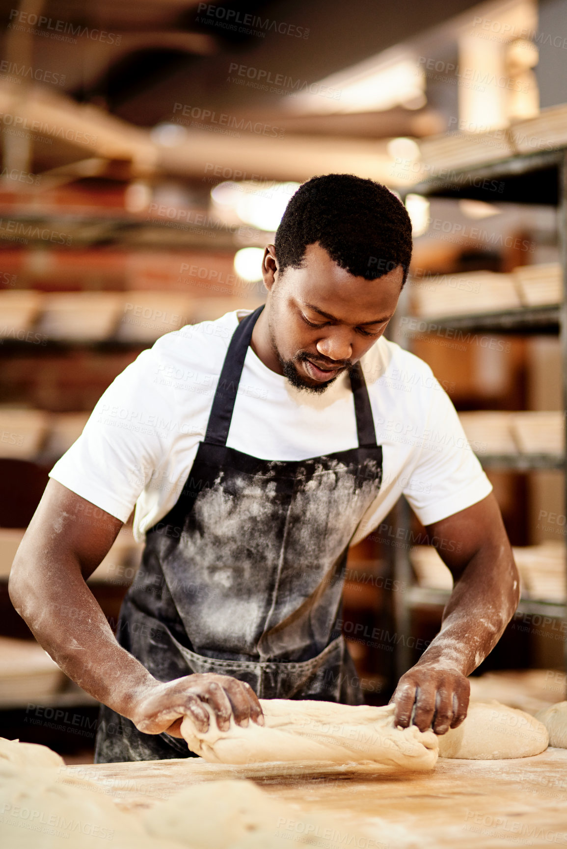 Buy stock photo Male person, work and baking bread in kitchen as small business or entrepreneur in cafe or bakery. Black man, pastry chef and restaurant in preparing sourdough recipe with pride, skill and confidence