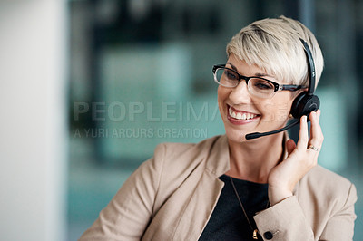 Buy stock photo Shot of a young businesswoman wearing a headset while working in an office