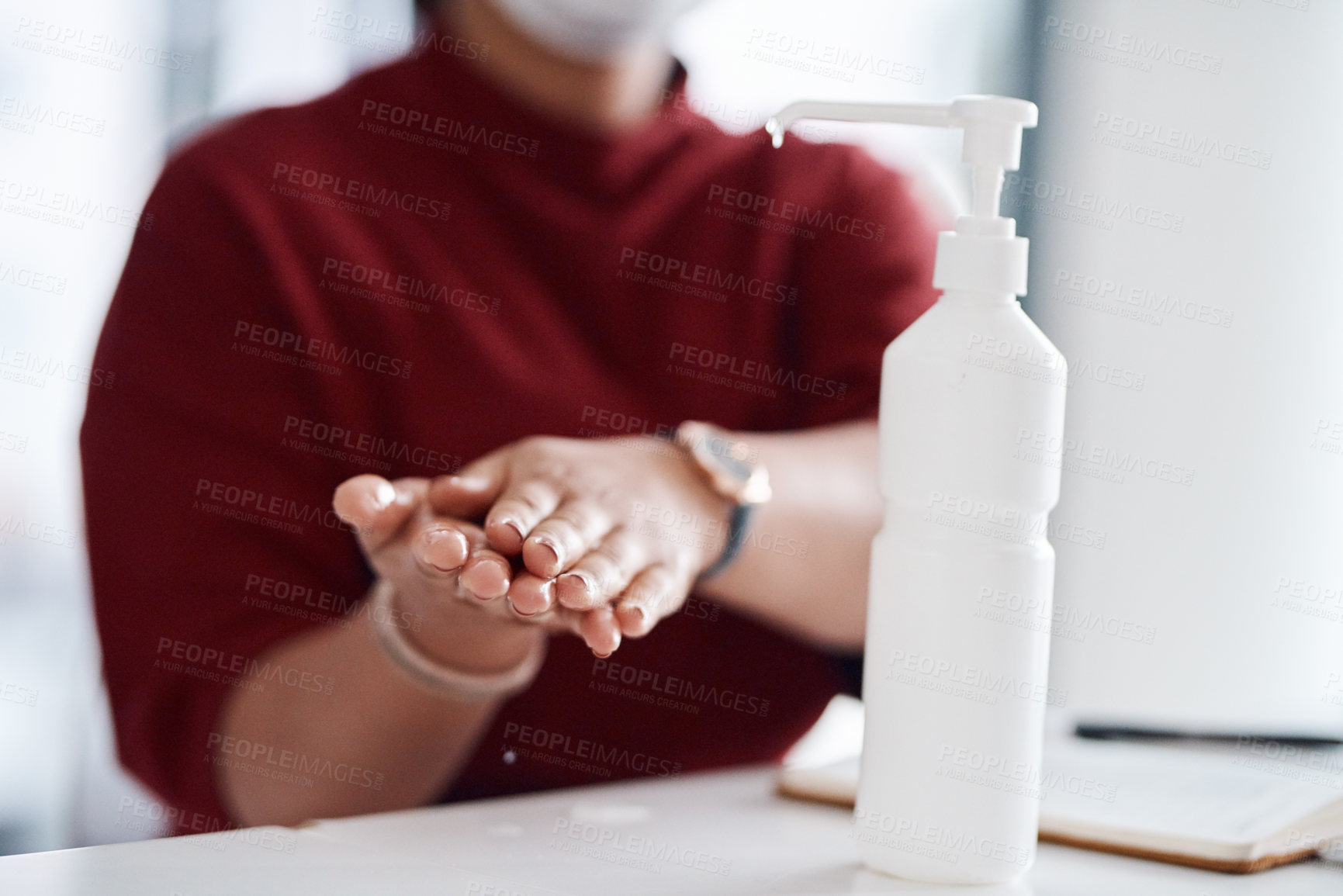 Buy stock photo Closeup shot of an unrecognisable businesswoman using hand sanitiser in an office