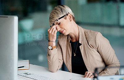 Buy stock photo Shot of a young businesswoman looking stressed out while working in an office